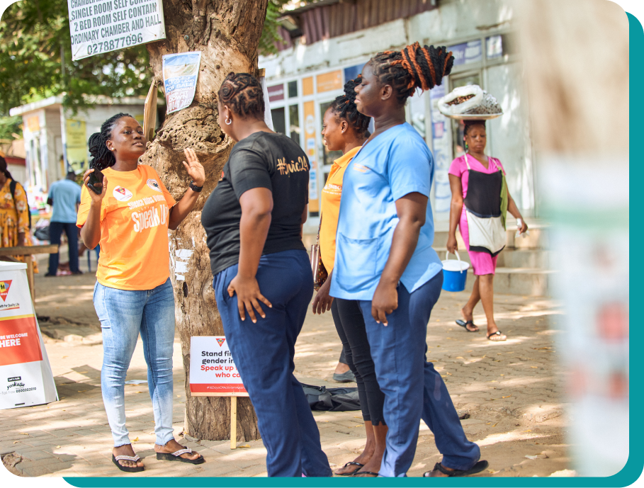 Group of people holding hands and smiling at the camera from a birds eye view